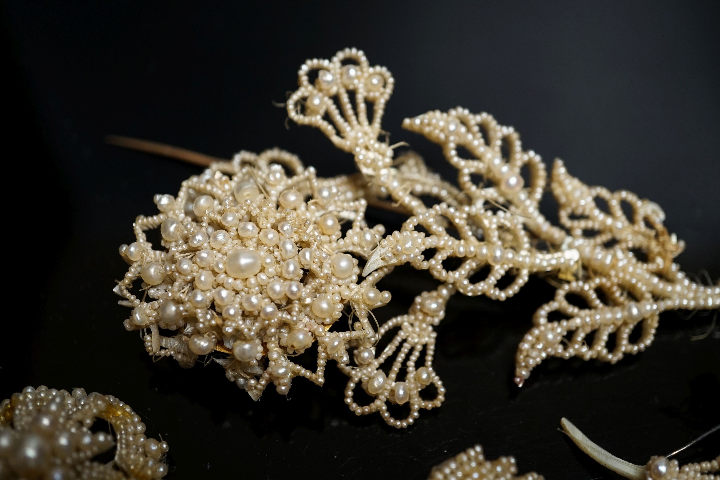 A 19th century seed pearl set flower brooch, 95mm and five other pieces of seed pearl jewellery.